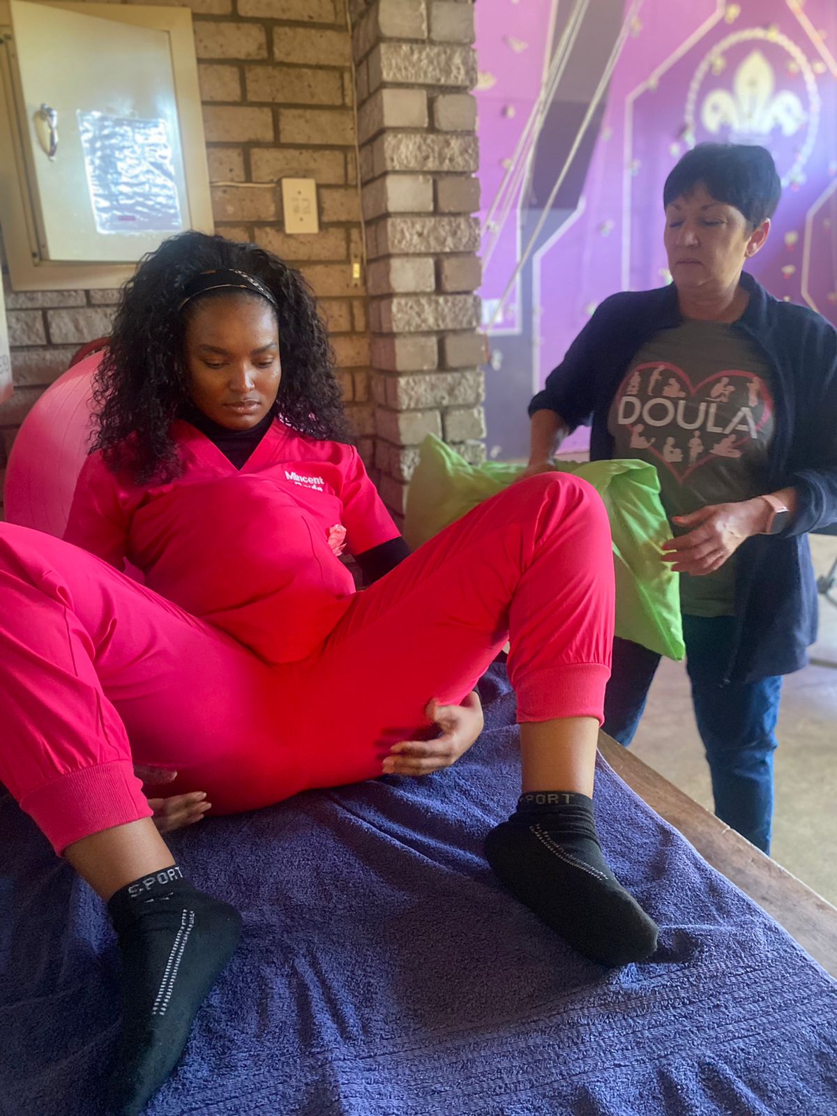 Trainer demonstrating a supported birthing position during a practical session